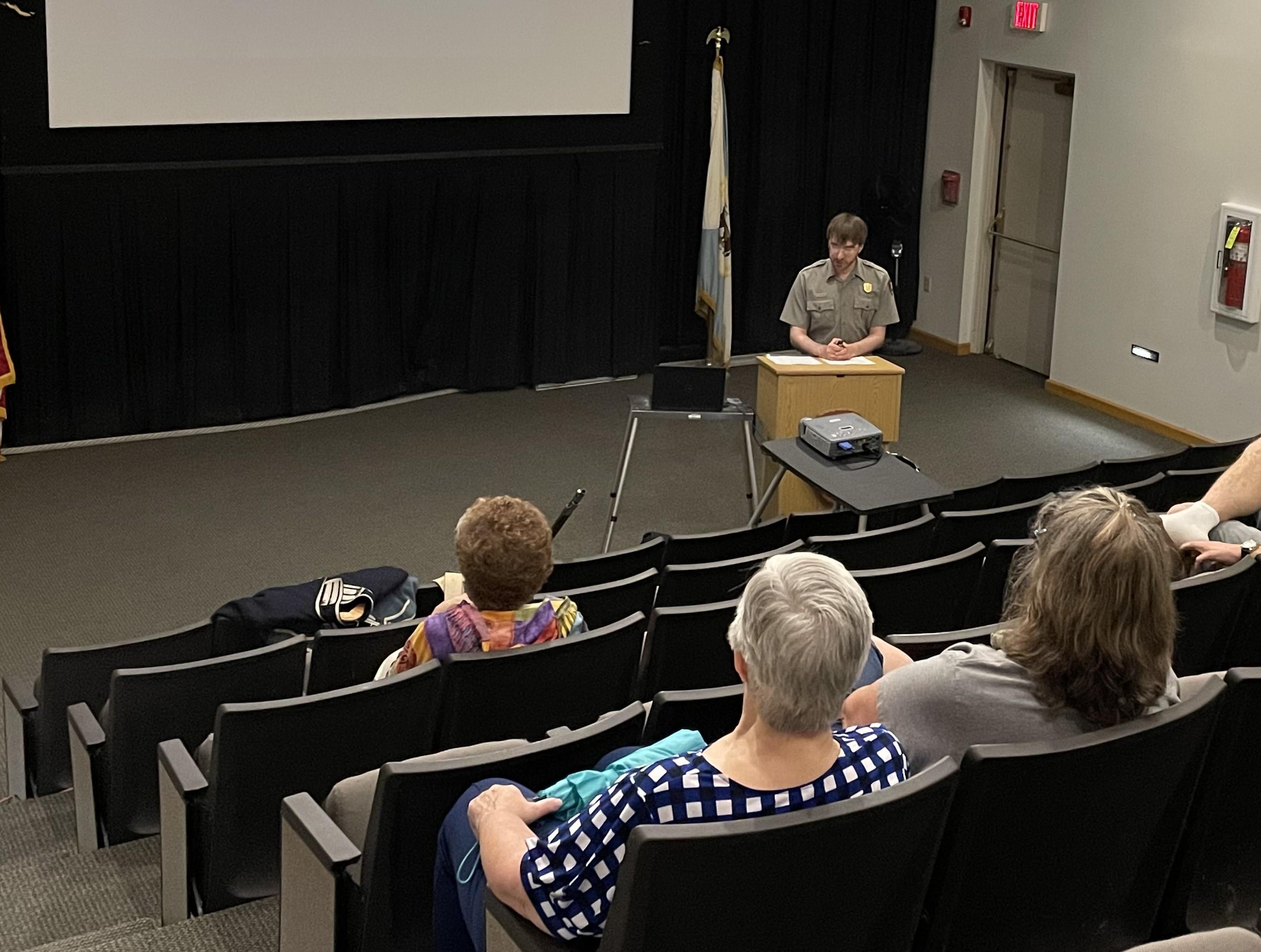 A park ranger presents a program in the auditorium.