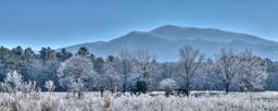 A thick layer of frost covers the fields, trees, and mountains in Cades Cove.